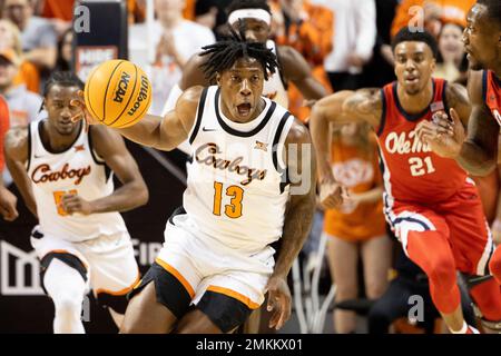 Oklahoma State's Quion Williams (13) brings the ball up the court during  the first half of an NCAA college basketball game against Mississippi in  Stillwater, Okla., Saturday, Jan. 28, 2023. (AP Photo/Mitch