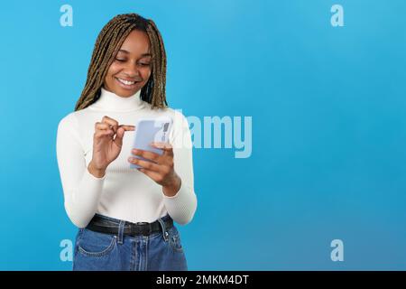 African smiling woman using the mobile phone Stock Photo