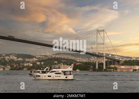 Istanbul, Turkey - August 31, 2022: Sunset of Bosphorus strait, with Bosphorus Bridge, or Bogazici Koprusu, connecting Europe and Asia, from Ortakoy district Stock Photo