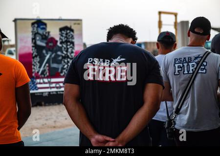 U.S. service members deployed to Prince Sultan Air Base, Kingdom of Saudi Arabia, stand beside firefighters, assigned to the 378th Expeditionary Civil Engineer Squadron, during the lighting of a mural, Sept. 10, 2022, in honor of the victims and first responders who passed away on September 11, 2001. Since the events of 9/11, the U.S. has deployed hundreds of thousands to the outer limits of its American borders and to every corner of the globe to eradicate terrorism. Stock Photo