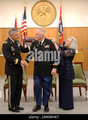 Maj. Gen. Jansen D. Boyles, adjutant general of Mississippi, and Josephine Austin, pin the rank of colonel on Lawrence Austin, Sr., during Austin's promotion ceremony at Grenada County Court House, Grenada, Mississippi, September 10, 2022. Austin is tasked with overseeing the Mississippi National Guard’s Military Justice program and presiding over Courts Martial and administrative proceedings. Stock Photo