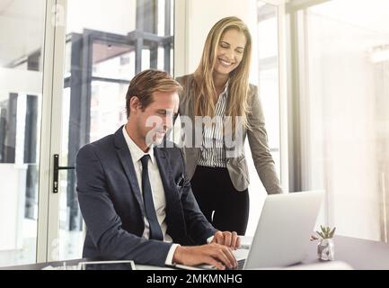 Workplace synergy. a two executives working together in an office. Stock Photo