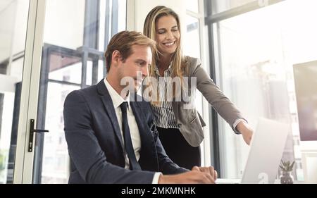 Youre on the right track here. a two executives working together in an office. Stock Photo