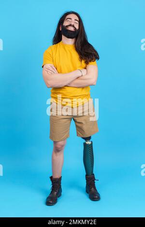 Cool man with a leg prosthesis standing with arms crossed Stock Photo