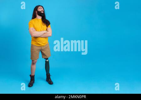 Smiling man with prosthetic leg looking to the copy space aside Stock Photo