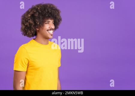 African man smiling while looking aside and standing Stock Photo