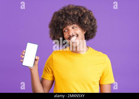 Smiley african man holding a mobile with a blank screen Stock Photo