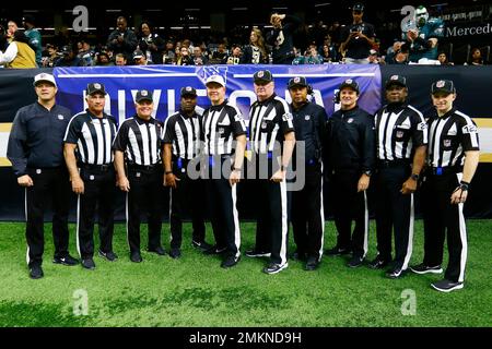 Officials, from left to right, replay official Kevin Brown, down judge  Michael Dolce, field judge Jimmy Buchanan, umpire Bryan Neale, referee  Shawn Smith, back judge Dino Paganelli, line judge Mark Steinkerchner and