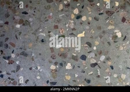 Gray dark texture of a grungy floor with small decorative stones for the background Stock Photo