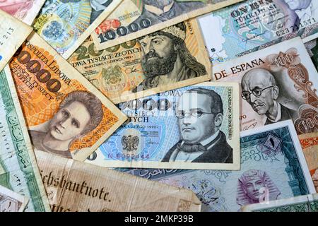 various old cash money banknotes from different countries of the world, stack of multiple currencies, pile of vintage retro bills of different origins Stock Photo