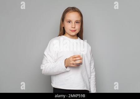 Pretty young child girl drinks milk without lactose, portrait Stock Photo