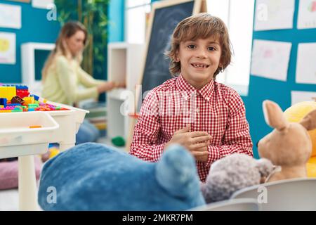 Teacher and toddler playing at kindergarten Stock Photo