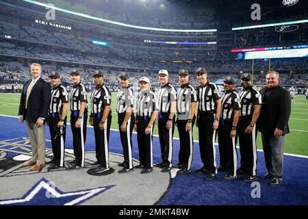 Officials, from left to right, replay official Kevin Brown, down judge  Michael Dolce, field judge Jimmy Buchanan, umpire Bryan Neale, referee  Shawn Smith, back judge Dino Paganelli, line judge Mark Steinkerchner and