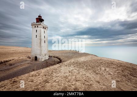 Clouds drift over Rubjerg Knude Fyr lighthouse and Rubjerg Knude shifting sand dune on the coast of North Jutland, Denmark Stock Photo