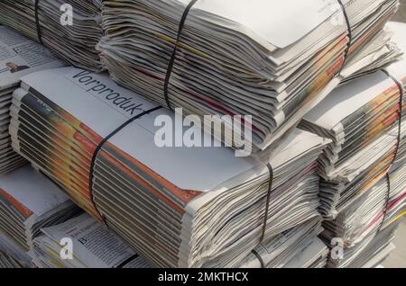 Germany April 2021: A pile of newspapers on a sidewalk Stock Photo