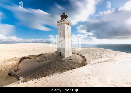 Clouds drift over the Rubjerg Knude Fyr lighthouse on the Rubjerg Knude shifting sand dune on the coast of North Jutland, Denmark Stock Photo