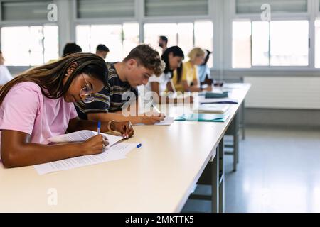 Group of high school students doing an exam in classroom Stock Photo