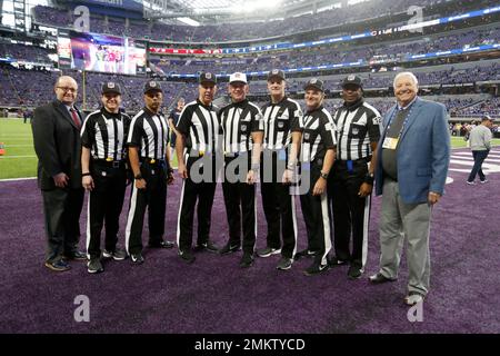 Game officials pose on the field before an NFL football game between the Minnesota  Vikings and the Chicago Bears, Sunday, Dec. 30, 2018, in Minneapolis. Shown  are replay assistant Willie Vizoso, from