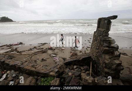 Indonesian rescuers search for the bodies of tsunami victims in