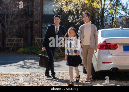 A young couple pick up the kids from school Stock Photo