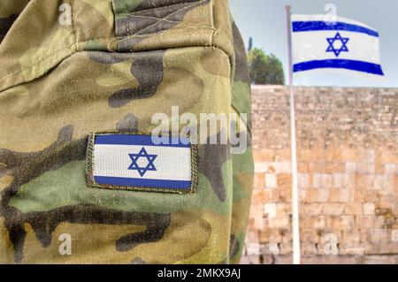 Military man posing in front of Israel flag and The Western Wall background in jerusalem Stock Photo