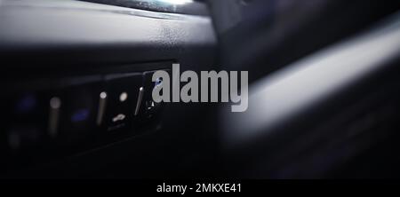 The process of choosing climate control in the car. Man regulating temperature on car air condition. Modern car interior Stock Photo