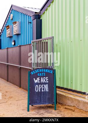 A 'We Are Open' sign outside the green and blue corrugated wall of the Beachcomber Cafe in St Anne's, Lancashire, UK Stock Photo
