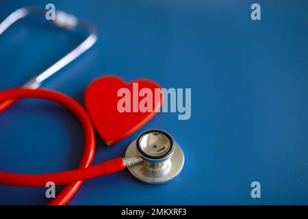 Doctor at his desk in the clinic's office. Stethoscope, test tubes, laptop, prescriptions, glasses on table. Stock Photo