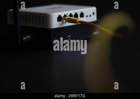 Modern dual band wireless router. Man working in the background. Fast wireless internet concept. Stock Photo