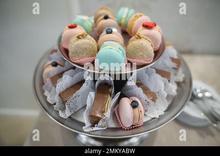 various delicious macaron cookies on a round stand tray Stock Photo