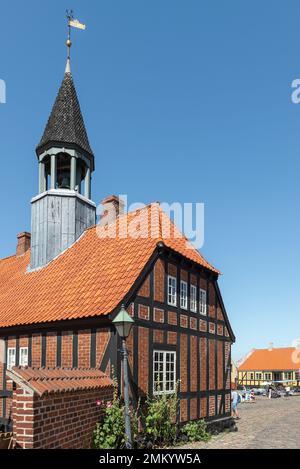 The old town hall of Ebeltoft, Djursland, Denmark made of half-timbering, red brick and with tower in the sun against a blue sky Stock Photo
