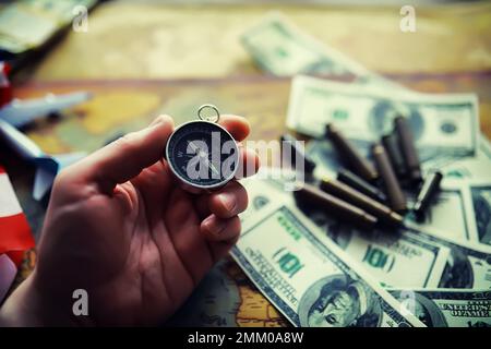 Magnetic compass. The concept of finding successful solutions to problems. Compass, map, sleeves, hands. Stock Photo