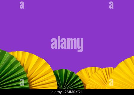 Mardi gras festive traditional color background. Abstract background yellow, green, purple. Paper fans Mardi gras celebration Stock Photo