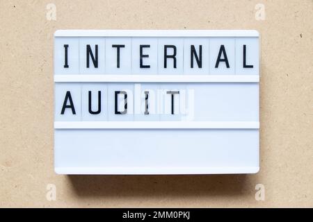 Lightbox with word internal audit on wood background Stock Photo
