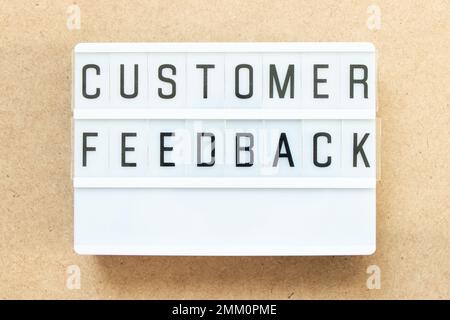 Lightbox with word customer feedback on wood background Stock Photo