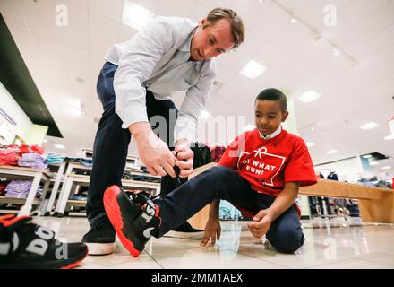 IMAGE DISTRIBUTED FOR JCPENNEY - Dallas Cowboys linebacker Sean Lee, left,  shops alongside Ajion Lair, 18, from the Boys & Girls Club of Greater Dallas  as he selects gifts for his family