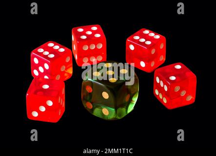 red and green translucent plastic dice. isolated cubes on black background. playing and gambling concept. casino and winning money. risk taking. Stock Photo