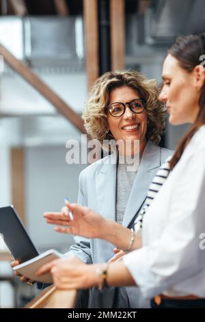 business women having a discussion with each other. Professional women talking about their workflow and progress. Female entrepreneurs brainstorming o Stock Photo