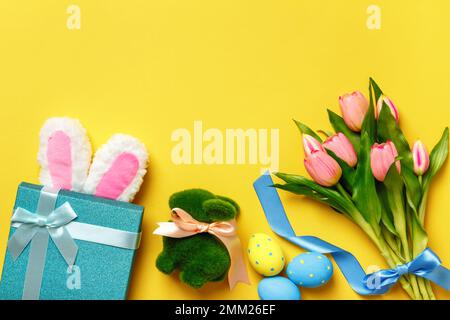Easter composition. Holiday symbols on yellow background with copy space. Stock Photo