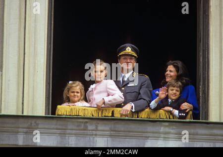 Carl XVI Gustaf, King of Sweden. Born 30 april 1946.  The King Carl XVI Gustaf Queen Silvia their children, princess Madeleine, crown princess Victoria, prince Carl Philip, in an open window of the royal castle in Stockholm celebrating the king's birthday, 30 april 1988. Stock Photo