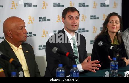 Oakland Athletics president Dave Kaval, left, talks to Reggie