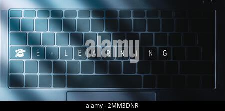 Laptop keyboard with blue light and E-learning text on buttons and graduation cap. Webinar. Online education. Distance courses. Stock Photo