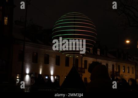 photo of a glowing circular installation on the street at night Stock Photo