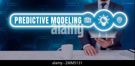 Hand writing sign Predictive Modeling. Word for maintenance strategy driven by predictive analytics Stock Photo