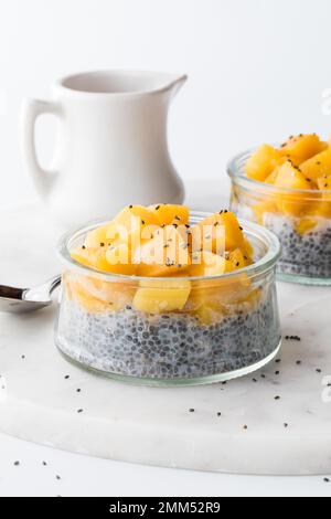 A close up of a sweet chia pudding parfait topped with diced pieces of mango. Stock Photo