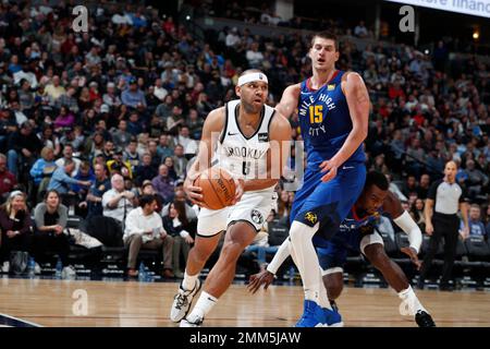 Philadelphia 76ers' Joel Embiid, center right, of Cameroon, puts up the  shot as he splits between Brooklyn Nets' Jared Dudley, center left, and  Jarrett Allen, right, during the second half in Game