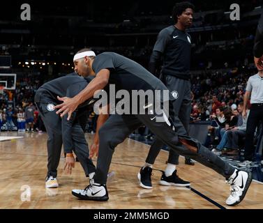 Philadelphia 76ers' Joel Embiid, center right, of Cameroon, puts up the  shot as he splits between Brooklyn Nets' Jared Dudley, center left, and  Jarrett Allen, right, during the second half in Game