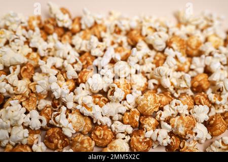 Popcorn background. Caramel popcorn and salted popcorn mixed together. Close-up, shallow depth of field, top view. Stock Photo