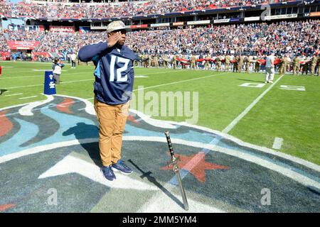 Hall of Fame linebacker Robert Brazile raises a sword as the