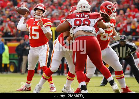 Kansas City Chiefs quarterback Patrick Mahomes (15) is chased by  Jacksonville Jaguars defensive tackle Corey Peters (98) during the second  half of an NFL football game, Sunday, Nov. 13, 2022 in Kansas